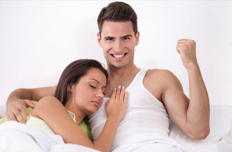 Strong man and a girl lying in bed